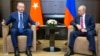 FILE - Turkish President Recep Tayyip Erdogan (L) speaks to Russian President Vladimir Putin, during their meeting in the Bocharov Ruchei residence in the Black Sea resort of Sochi in Sochi, Russia, Sept. 17, 2018.