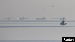 FILE - Russian fighter jets fly over vessels in the Black Sea off Crimea as part of operations to stop three Ukrainian navy ships from entering the Sea of Azov, Nov. 25, 2018.