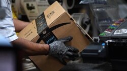 Seorang pekerja tampak mengemas barang pesanan untuk dikirimkan di kantor perusahaan Amazon di Baltimore, Maryland, pada 30 April 2019. (Foto: Reuters)