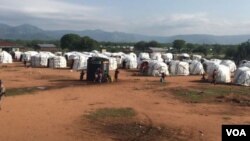 Plastic tents sprout on bare ground at Dambala Fachana, intended as a temporary refugee camp in northern Kenya. With recent heavy rains, some refugees have been moved to higher ground. (D. Gelmo/VOA)