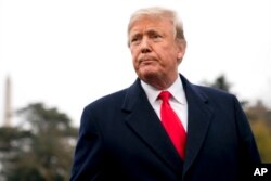 FILE - President Donald Trump listens to a question as he speaks to members of the media on the South Lawn of the White House in Washington, Nov. 26, 2018.