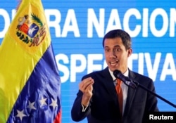 FILE - Venezuelan opposition leader Juan Guaido, who many nations have recognized as the country's rightful interim ruler, speaks during a meeting with representatives of the oil sector in Caracas, Venezuela, Feb. 5, 2019.