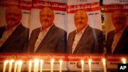 Candles, lit by activists, protesting the killing of Saudi journalist Jamal Khashoggi, are placed outside Saudi Arabia's consulate, in Istanbul, during a candlelight vigil, Oct. 25, 2018.