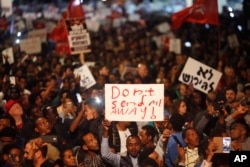 FILE - Asylum seekers protest against deportation in Tel Aviv, Israel, Feb. 24, 2018.