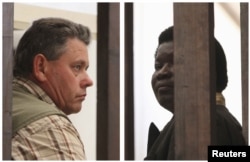 A combination photo shows Zimbabwean safari operator Honest Ndlovu (R) and fellow countryman and hunter Theo Bronkhorst waiting to appear in Hwange magistrates court, July 29, 2015.