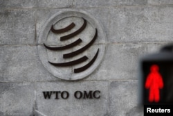 FILE - A logo is pictured outside the World Trade Organization (WTO) headquarters next to a red pedestrian traffic light, in Geneva, Switzerland, Oct. 2, 2018.