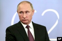 Russian President Vladimir Putin speaks to the media after the G-20 summit in Buenos Aires, Argentina, Dec. 1, 2018.