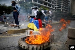 Masked anti-government demonstrators protest against the installation of a constitutional assembly in Caracas, Venezuela, Aug. 4, 2017.