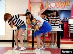 Michiko Ohashi (C), wearing a costume decorated with snacks, performs with other members of pop group Pottya at a fan meeting celebrating her birthday in Tokyo, Japan, Oct. 16, 2016.