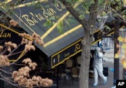 An investigator works outside the Bataclan concert hall in Paris, Nov. 14, 2015.