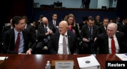 Then-FBI Director James Comey (L), then-U.S. Director of National Intelligence James Clapper (C) and then-CIA Director John Brennan (R) take their seats to testify at a hearing on Capitol Hill in Washington, Feb. 25, 2016. President Donald Trump has refer