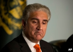 FILE - Pakistan's Foreign Minister Shah Mahmood Qureshi gestures during a briefing at foreign ministry in Islamabad, Pakistan, Wednesday, Sept. 5, 2018.