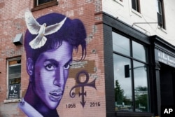 FILE - A mural honoring the late Prince adorns a building in the Uptown area of Minneapolis, Aug 28, 2016. The rock star died of an overdose at the age of 57.