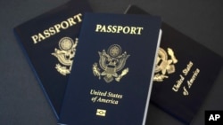 In this May 9, 2017 photo, U.S. passports lie on a table in Dallas, Texas. The U.S. State Department is in the middle of a record year for processing passport applications, with 20.5 million renewals and applications for new passports expected.