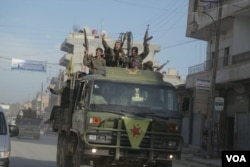 FILE - Members of the Kurdish People's Protection Units (YPG) return to Qamishli after a battle near Hasaka, March 14, 2015. (Credit: Z. Omar/VOA)