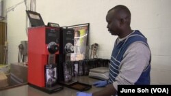 FILE - Manyang Kher, Founder of 734 Coffee, grinds coffee at his warehouse in Springfield, Virginia. (J. Soh/VOA)