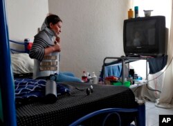 Socorro Reyes sits alone in her room at the Asociacion Casa Del Migrante "La Divina Providencia" group house Thursday, July 19, 2018 in San Luis, Sonora, Mexico.