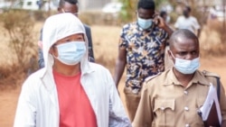 Lin Yunhua is pictured at left, outside the High Court in Malawi, Sept. 28, 2021. (EIA photo)
