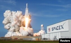 FILE - A SpaceX Falcon Heavy rocket lifts off from historic launch pad 39-A at the Kennedy Space Center in Cape Canaveral, Florida, Feb. 6, 2018.