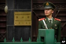 A Chinese paramilitary policeman stands guard outside of the North Korean Embassy in Beijing, April 20, 2017.