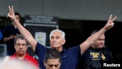 Roger Stone reacts as he walks to microphones after his appearance at Federal Court in Fort Lauderdale, Fla., Jan. 25, 2019.