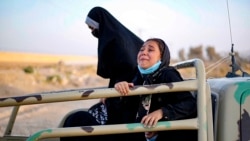 A handout picture made available by the Iranian Red Crescent on Aug. 19, 2021, shows Afghan women and children on the back of a truck at the Iran-Afghanistan border between Afghanistan and the southeastern Iranian Sistan and Baluchestan province.