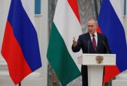 Russian President Vladimir Putin speaks during a news conference in Moscow, Russia, Feb. 1, 2022.