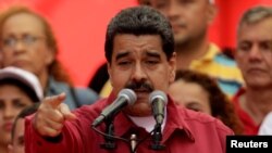 FILE - Venezuela's President Nicolas Maduro gives a speech at a rally against U.S President Donald Trump in Caracas, Venezuela, Aug. 14, 2017.