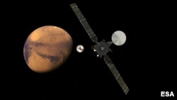 FILE - The ExoMars Trace Gas Orbiter and its entry, descent and landing demonstrator module, Schiaparelli, approaching Mars.