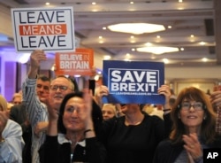 FILE - Supporters during a "Leave Means Leave Rally" are seen at the National Conference Center, Solihull, central England, Sept 30, 2018, as the ruling Conservative Party starts its annual conference.