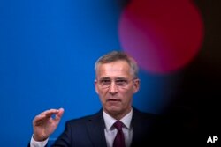 NATO Secretary General Jens Stoltenberg talks to journalists during a news conference at the NATO headquarters in Brussels, Oct. 24, 2018.