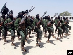 FILE - Hundreds of newly trained al-Shabab fighters perform military exercises in the Lafofe area 18 km south of Mogadishu, Somalia, Feb. 17, 2017.