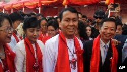 Phyo Min Thein, second from right, Yangon region chief minister, smiles as he takes part in cerebrations to mark Lunar New Year along with local Chinese at Chinatown, Jan. 28, 2017, in Yangon, Myanmar.