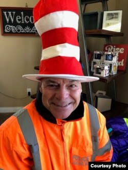 In the past five years, Woolford has collected 55 hats to wear as he directs traffic outside Ashland’s middle and high schools. (Courtesy Photo).