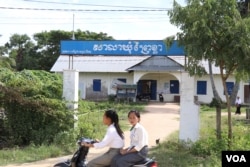Students drive past the Prey Khla commune office in Takeo province, Nov. 27, 2017.