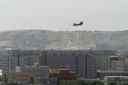 A US military helicopter is pictured flying above the US embassy in Kabul on August 15, 2021.