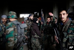 Syrian army soldiers prepare for battle with rebels at the Ramouseh front line, east of Aleppo, Syria, Dec. 5, 2016.