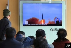 FILE - People watch a TV screen showing file footage of North Korea’s missile launch at Seoul Railway Station in Seoul, South Korea, Nov. 21, 2017.
