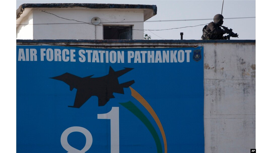 An Indian military commando is seen on the top of a building at the Indian air force base in Pathankot, India, Jan. 5, 2016, following a militant attack on the base.