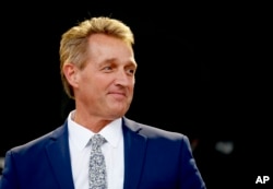 Sen. Jeff Flake, R-Ariz., looks on during an appearance at the Forbes 30 Under 30 Summit, Oct. 1, 2018, in Boston.