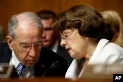 FILE - Senate Judiciary Committee Chairman Sen. Chuck Grassley, R-Iowa, talks with the Committee's ranking member Sen. Dianne Feinstein, D-California, on Capitol Hill in Washington, July 12, 2017.