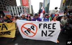 Protesters march to the venue of the Trans-Pacific Partnership signing in Auckland, New Zealand, Feb 4, 2016.