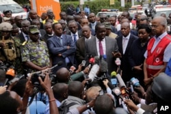 Kenya's Interior Minister Fred Matiangi speaks to the media at the scene of an extremist gunmen attack in Nairobi, Kenya, Jan. 16, 2019.