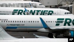 In this May 15, 2017, photo, Frontier Airlines jetliners sit at Denver International Airport in Denver.