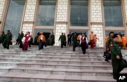 Lawmakers of the National League for Democracy party (NLD) and Military representatives leave the parliament after attending a regular session of the Union Parliament, August 25, 2016, in Naypyitaw, Myanmar.