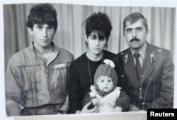Pictured is Tamerlan (C) Tsarnaev, accompanied by his father Anzor (L), mother Zubeidat and uncle Muhamad Suleimanov (R), in this photo courtesy of the Suleimanova family.