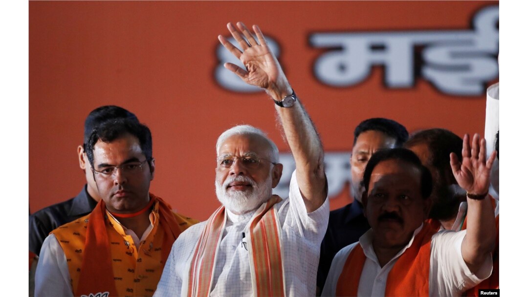 India's Prime Minister Narendra Modi waves toward his supporters during an election campaign rally in New Delhi, May 8, 2019.