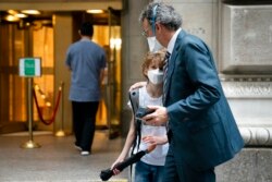 Students wear protective masks as they arrive for classes at The Lang School, in the Manhattan borough of New York, Oct. 4, 2021.