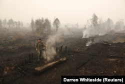 Seorang tentara memeriksa kebakaran lahan gambut di dekat Palangkaraya, Kalimantan Tengah (foto: ilustrasi).