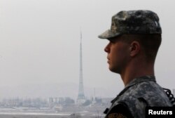 FILE - A U.S. soldier is seen while escorting journalists at a guard post in the truce village of Panmunjom in the demilitarized zone separating the two Koreas in Paju, north of Seoul.